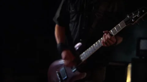 Close-up of a guitarist performing in dim light Stock Footage 300114399