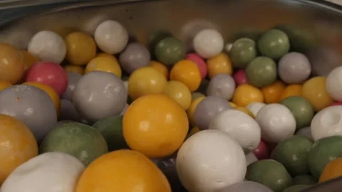 Close up gum balls falling in slow motion Stock Footage 247203195