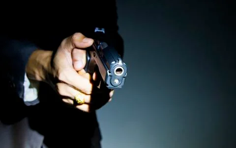 Close up gunman on dark background Stock Photos