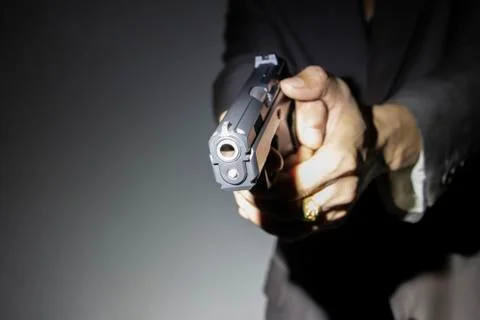 Close up gunman on dark background Stock Photos