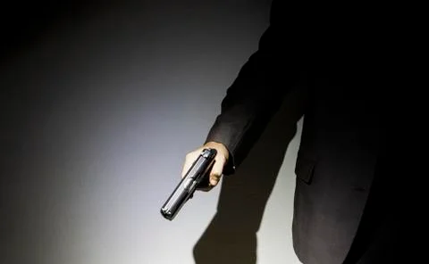 Close up gunman on dark background Stock Photos