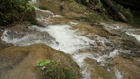 Close-up of a gurgling stream surrounded by rocks Stock Footage 346650488