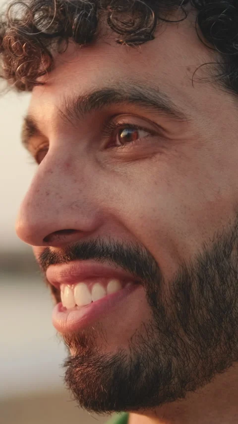 Close up, guy with beard dressed in green shirt laughs and talks to someone Stock Footage 253927675