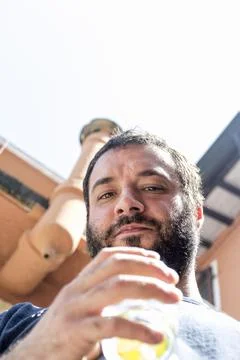 Close up of a guy with black beard and cocktail Stock Photos