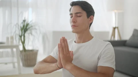 Close Up Guy Doing Yoga at Home Keeping His Eyes Closed Breathing Slowly. Sport Видео 134708770