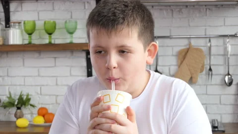 Close-up of a guy drinking from a paper cup through a straw. The guy drinks soda Stock Footage 233724085