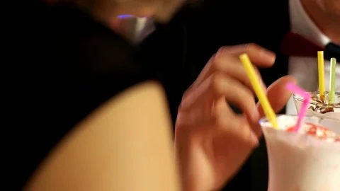 Close-up of a guy drinks a chocolate milkshake Stock Footage 75812516