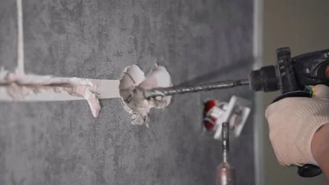 Close-up of a guy with a hammer drill and socket holes Stockbeeldmateriaal 147077366