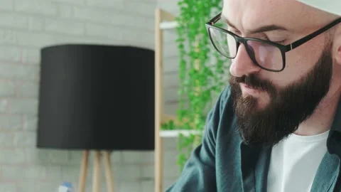 Close up of guy that learn online courses using a tablet and write notice in his Stock Footage 168530188