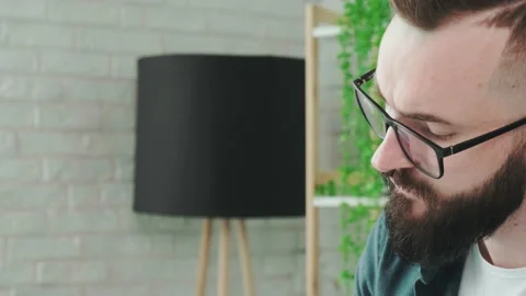 Close up of guy that learn online courses using a tablet and write notice in his Stock Footage 168976376