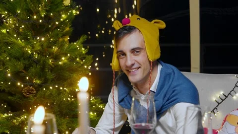 Close-up of a guy looking at the camera for the New Year. Friends celebrate the Stock Footage 167248228