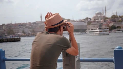 Close-up of guy looking through tourist binoculars on seashore. Stock Footage 253299749
