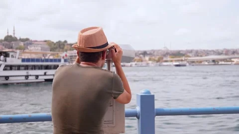 Close-up of guy looking through tourist binoculars on seashore. Stock Footage 253315786