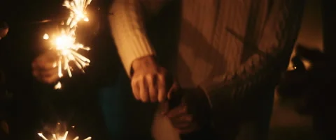 Close up of a guy opening the sparkling wine bottle at new years eve Stock Footage 202258238