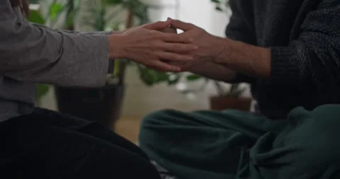 Close up of guy pouring hot tea from teapot into mug and giving it to his Stock Footage 318079892