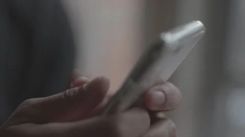 Close up of guy scrolling on phone with both hands Stock Footage 151469801