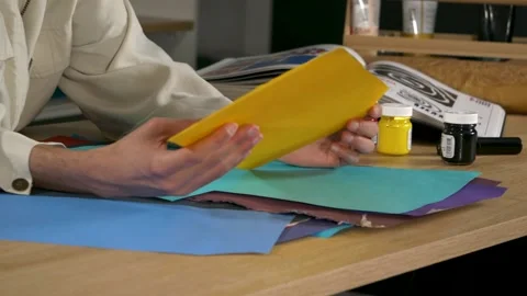 Close up of guy, touch and think with piece of color paper for art and crea.. Video stock 232195387