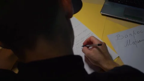 Close-up, guy writes in draft, takes notes, trains. camera is behind, back head Stock Footage 121680401