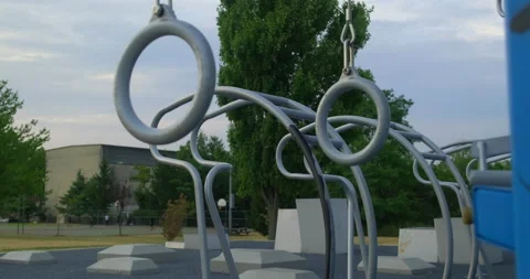 Close up of gymnastics rings exercise bars in a fitness area on a summer day Stock Footage 202106021