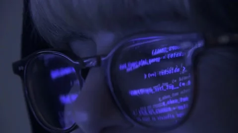 Close up of Hacker in front of his computer screen reflecting in glasses coding  Stock Footage 150427197