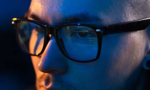 Close up of hacker in glasses looking at screen Stock Photos