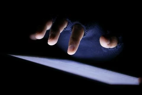 Close up of hacker hand stealing data from digital tablet 스톡 사진