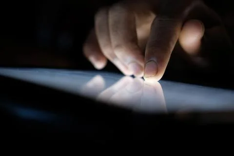 Close up of hacker hand stealing data from digital tablet Stock Photos