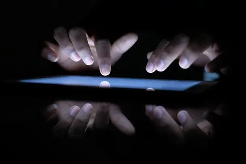 Close up of hacker hand stealing data from digital tablet Stock Photos