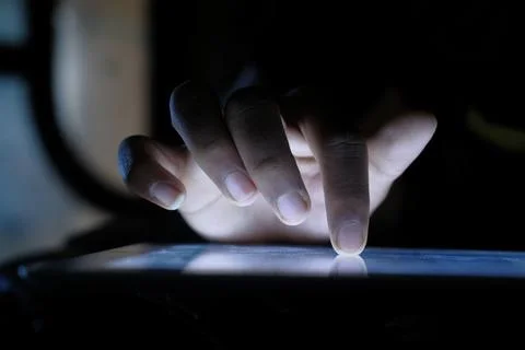 Close up of hacker hand stealing data from digital tablet Stock Photos