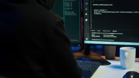 Close up of hacker running code in apartment on PC monitors Stock Footage 275752829