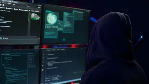 Close up of hacker running code in apartment on PC monitors Stockfoto's