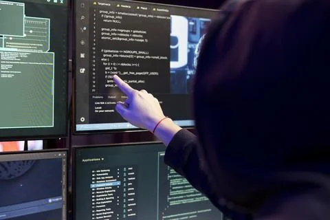 Close up of hacker in secret bunker coding on PC, using AI to evade security Stock Photos