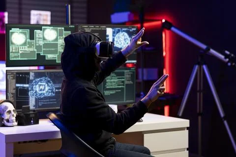 Close up of hacker in secret lair using AI to break into computer systems 库存照片