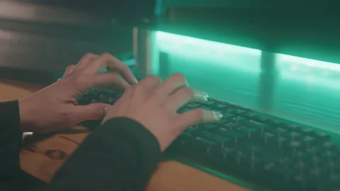Close-up of Hacker Typing Quicky on Computer Keyboard in Dark Room Stock Footage 208787014