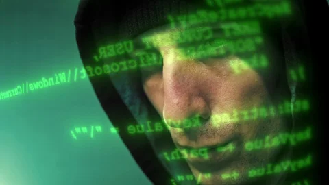 Close-up of the hacker working on a computer while green code characters running Stock Footage 120564488