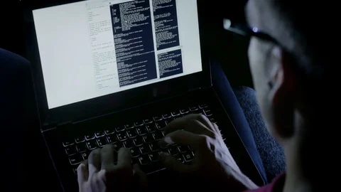 Close-up of hacker working illegally while typing on the laptop Stock Footage 72543608