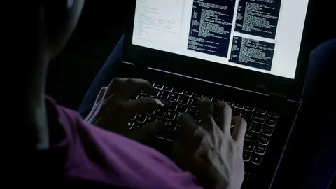 Close-up of hacker working illegally while typing on the laptop 動画素材 72544113