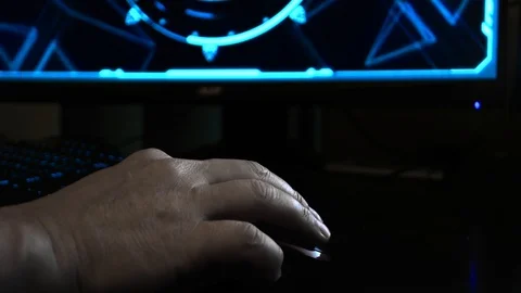 Close up of a hacker's hand using a computer mouse, hi-tech screen in the Stock Footage 107589130