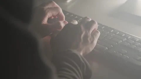 Close-up of Hacker's Hands as He Types in Computer Light Stock Footage 210219110