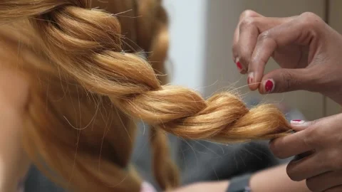 Close-Up of Hair Braiding Process on Long Blonde Hair Stock Footage 322060490