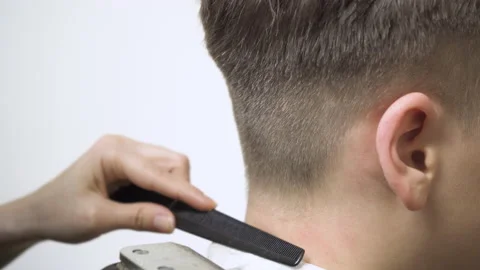 Close-up of hair clipper on the back of the head with a hair clipper. Video stock 148190351