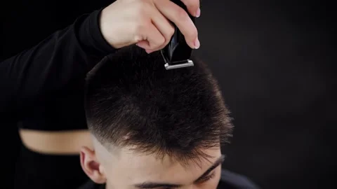 Close-up haircut of the client with an electric razor. Barber Shop Stock Footage 236192521