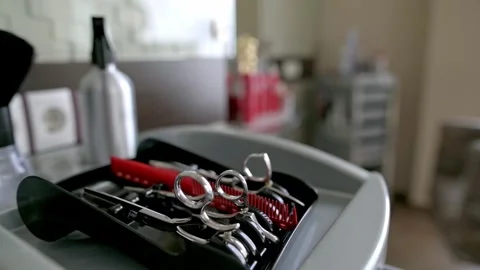 Close-up of hairdressing tools including scissors combs neatly arranged ready Video stock 280952548