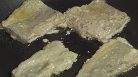 Close-up of hake fish pieces frying in a pan Stock-Footage 314808930