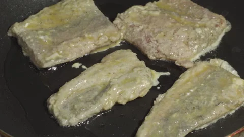 Close-up of hake fish pieces frying in a pan Stock-Footage 314809050
