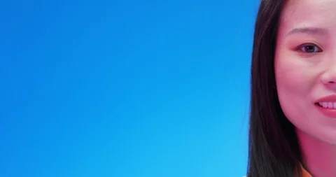Close up of half face of Asian cheerful pretty girl smiling joyfully and looking Stock Footage 125455463