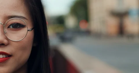 Close up of the half face of the Asian young pretty woman in glasses smiling Stock Footage 111451462