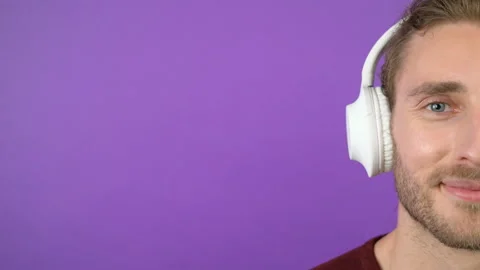 Close-up half face portrait of young man in big white headphones. Isolated on Stock Footage 145409097