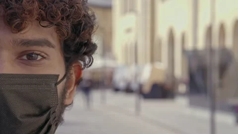 Close-up half face portrait of young man at the street. Wearing face mask. Stock Footage 163280917