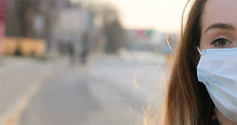 Close up of half face of sad Caucasian young woman in medical mask looking Stock Footage 126927831